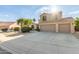Charming two-story home featuring a spacious driveway and a low-maintenance desert landscape at 9121 E Karen Dr, Scottsdale, AZ 85260