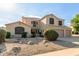 Charming two-story home featuring a spacious driveway and a low-maintenance desert landscape at 9121 E Karen Dr, Scottsdale, AZ 85260