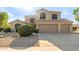 Charming two-story home featuring a spacious driveway and a low-maintenance desert landscape at 9121 E Karen Dr, Scottsdale, AZ 85260