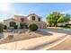 Charming two-story home featuring a spacious driveway and a low-maintenance desert landscape at 9121 E Karen Dr, Scottsdale, AZ 85260