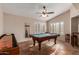 Spacious game room featuring a pool table and shuffleboard table, perfect for entertaining guests at 9121 E Karen Dr, Scottsdale, AZ 85260