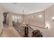 Open hallway with wrought-iron staircase and chandelier at 9121 E Karen Dr, Scottsdale, AZ 85260