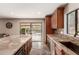 Bright kitchen with granite countertops, stainless steel appliances, and a view of the outdoor patio at 9121 E Karen Dr, Scottsdale, AZ 85260