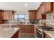 Updated kitchen with granite countertops, stainless steel appliances, and custom cabinets at 9121 E Karen Dr, Scottsdale, AZ 85260