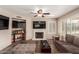 Comfortable living area boasts a fireplace, multiple TVs, and a large sectional sofa at 9121 E Karen Dr, Scottsdale, AZ 85260