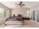Spacious main bedroom with a ceiling fan, large windows and convenient wardrobe storage at 9121 E Karen Dr, Scottsdale, AZ 85260