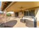 Covered patio features a ceiling fan, mounted TV, and comfortable wicker furniture set at 9121 E Karen Dr, Scottsdale, AZ 85260