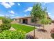 Beautiful backyard with artificial turf, desert landscaping, and patio at 9452 W Parkside Ln, Peoria, AZ 85383