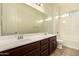 Bathroom featuring double sinks, a large mirror, and a shower-tub combination at 9452 W Parkside Ln, Peoria, AZ 85383