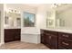 Bright bathroom with wood look tile, soaking tub, and separate vanities with granite countertops at 9452 W Parkside Ln, Peoria, AZ 85383