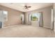 Spacious bedroom with neutral walls, carpet flooring, and large windows with natural light at 9452 W Parkside Ln, Peoria, AZ 85383
