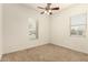 Bedroom featuring plush carpet and windows, providing natural light at 9452 W Parkside Ln, Peoria, AZ 85383