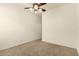 Minimalist bedroom with carpet flooring, ceiling fan, and natural light at 9452 W Parkside Ln, Peoria, AZ 85383