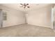 Large bedroom featuring plush carpeting, a ceiling fan, and natural light from multiple windows at 9452 W Parkside Ln, Peoria, AZ 85383