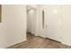 Bright entryway featuring wood look flooring and white walls with visible doorways at 9452 W Parkside Ln, Peoria, AZ 85383