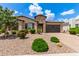 Beautiful single-story home with desert landscaping, stone accents, and a two-car garage at 9452 W Parkside Ln, Peoria, AZ 85383