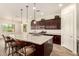 Kitchen with a granite island, wooden bar stools, and stylish pendant lighting at 9452 W Parkside Ln, Peoria, AZ 85383