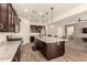 Spacious kitchen with granite countertops, a large island, and dark wood cabinetry at 9452 W Parkside Ln, Peoria, AZ 85383