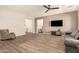 Spacious living room featuring tile floors, a ceiling fan, and a large picture window at 9452 W Parkside Ln, Peoria, AZ 85383