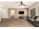 Bright living room features wood-look tile, ceiling fan, and an open floor plan at 9452 W Parkside Ln, Peoria, AZ 85383