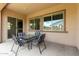 Covered patio with tile flooring, table, and chairs, perfect for outdoor dining at 9452 W Parkside Ln, Peoria, AZ 85383
