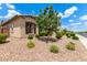 Charming single-story home with desert landscaping, dark shutters, and a lush tree in the front yard at 9452 W Parkside Ln, Peoria, AZ 85383