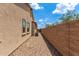 The home's side yard features desert landscaping and a stucco exterior at 9452 W Parkside Ln, Peoria, AZ 85383