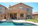 Home's backyard, featuring a pool, outdoor seating, and desert landscaping at 10490 E Morning Star Dr, Scottsdale, AZ 85255