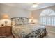 Inviting bedroom with a cozy bed, ceiling fan, and shuttered window, perfect for restful nights and relaxation at 10490 E Morning Star Dr, Scottsdale, AZ 85255