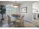 Elegant dining room featuring a glass-top table, comfortable chairs, and stylish decor with natural light at 10490 E Morning Star Dr, Scottsdale, AZ 85255