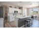 Modern kitchen featuring white cabinets, stainless steel appliances, and an island with seating at 10490 E Morning Star Dr, Scottsdale, AZ 85255