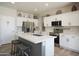 Modern kitchen with a large island, stainless steel appliances, white cabinets, and granite countertops at 10490 E Morning Star Dr, Scottsdale, AZ 85255