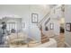 Bright, open-concept living area with high ceilings and view to dining area and staircase at 10490 E Morning Star Dr, Scottsdale, AZ 85255