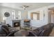 Bright living room features a fireplace, ceiling fan, and neutral color palette, perfect for relaxing and entertaining at 10490 E Morning Star Dr, Scottsdale, AZ 85255