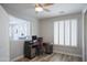 Well-lit home office features a large desk, shutters, and wood-look floors, creating a productive workspace at 10490 E Morning Star Dr, Scottsdale, AZ 85255
