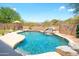 Backyard pool with a waterfall feature, desert landscaping, and plenty of sunshine at 10490 E Morning Star Dr, Scottsdale, AZ 85255