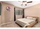 Inviting bedroom illuminated by natural light from a window and features a ceiling fan at 1121 W Windjammer Dr, Gilbert, AZ 85233