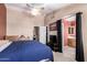 Cozy bedroom featuring a ceiling fan, a sleeping area and an ensuite bathroom at 1121 W Windjammer Dr, Gilbert, AZ 85233