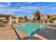 Inviting community pool area with lounge chairs and shade structures for residents at 1121 W Windjammer Dr, Gilbert, AZ 85233