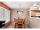 Bright dining room area with wood-look tile flooring and a stylish light fixture at 1121 W Windjammer Dr, Gilbert, AZ 85233