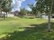 Expansive grassy common area surrounded by mature trees, offering a serene environment within the residential community at 1121 W Windjammer Dr, Gilbert, AZ 85233