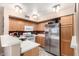 Well-lit kitchen featuring stainless steel appliances and ample counter space at 1121 W Windjammer Dr, Gilbert, AZ 85233