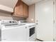 Practical laundry room equipped with a washer and dryer, complemented by overhead storage at 1121 W Windjammer Dr, Gilbert, AZ 85233