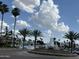 Beautiful lake community entrance featuring a decorative water fountain and palm trees at 1121 W Windjammer Dr, Gilbert, AZ 85233