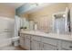 Well-lit bathroom featuring a large vanity, shower with tub, and neutral color scheme at 11375 E Sahuaro Dr # 2015, Scottsdale, AZ 85259