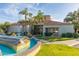 Stunning clubhouse entrance with lush landscaping, a decorative fountain and beautiful tile roof at 11375 E Sahuaro Dr # 2015, Scottsdale, AZ 85259