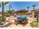 Beautiful community pool area with palm trees, fountains, outdoor seating and dining at 11375 E Sahuaro Dr # 2015, Scottsdale, AZ 85259