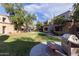Lush courtyard with barbecue and bench seating nestled in a garden setting at 11375 E Sahuaro Dr # 2015, Scottsdale, AZ 85259