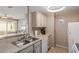 Functional kitchen featuring stainless steel sink and modern appliances with easy access to living area at 11375 E Sahuaro Dr # 2015, Scottsdale, AZ 85259