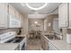 Well-equipped kitchen with a stove and sink with a view into the dining area at 11375 E Sahuaro Dr # 2015, Scottsdale, AZ 85259